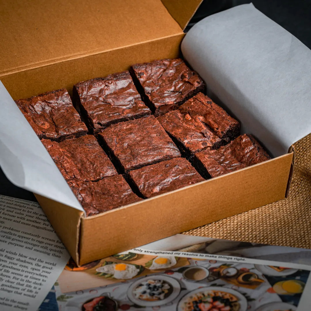 Box of nine Delight with Pan Di Stelle Spread brownies arranged in a neat grid, featuring glossy cracked tops and premium bakery-style packaging.